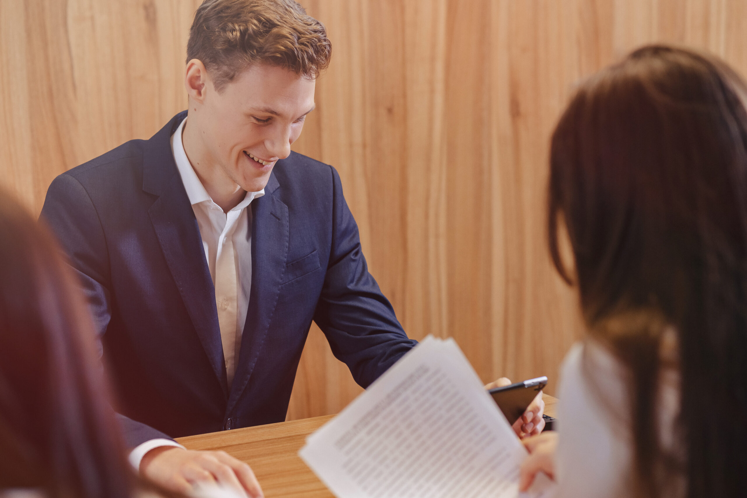 Woman reviewing documents with attorney in office