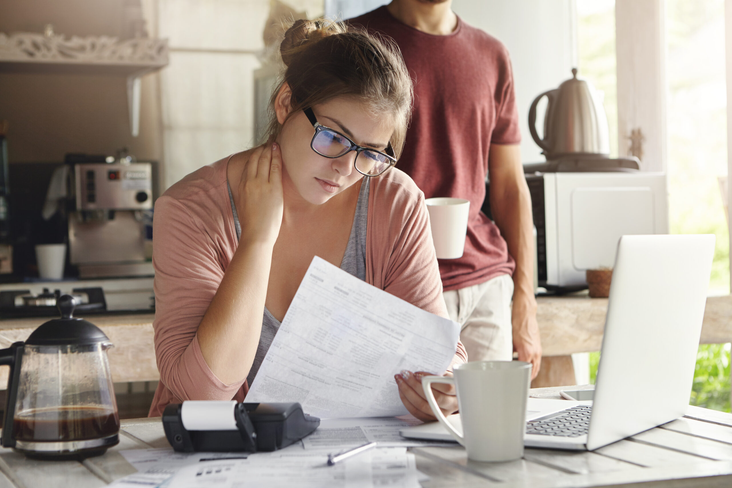Woman reviewing loan documents with concern